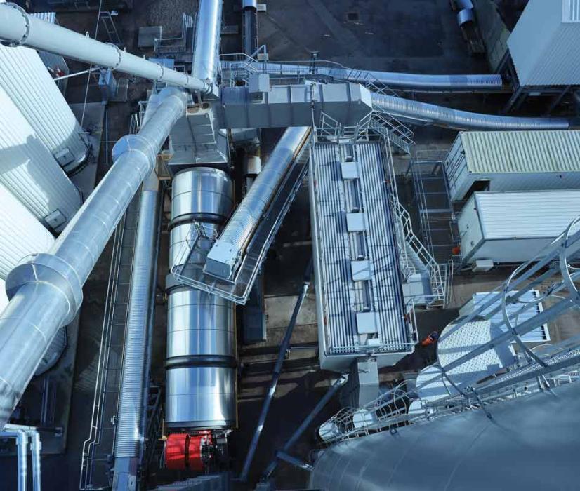 Part of the cold-feed arrangement showing the bitumen tanks, dryer drum with RAH50 central inlet ring, dust filtration system, and filler silo