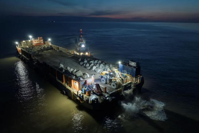 Aggregate Industries’ SeaRock barge carrying the armour-stone on the final leg of the journey to Blue Anchor Beach