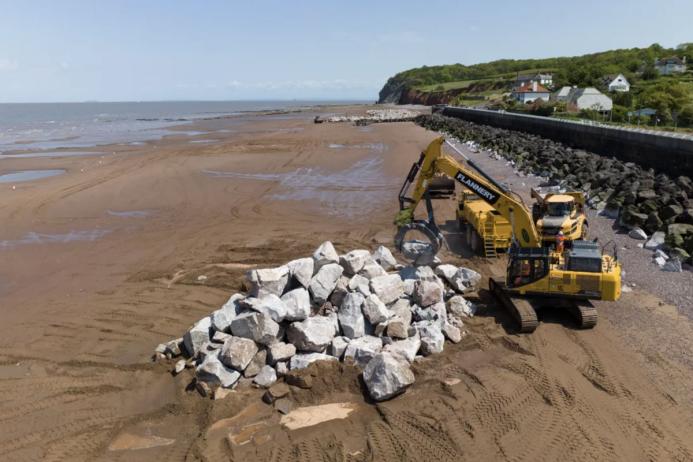 The granite armour-stone being manipulated on Blue Anchor Beach