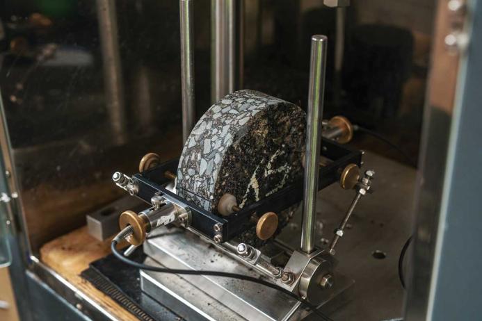 A core sample under test in the Nottingham Asphalt Tester (NAT), which rapidly tests the stiffness and fatigue of bituminous mixtures