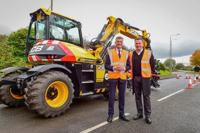 L-R: Transport Minister Mark Harper and JCB chief executive officer Graeme Macdonald with the JCB Pothole Pro