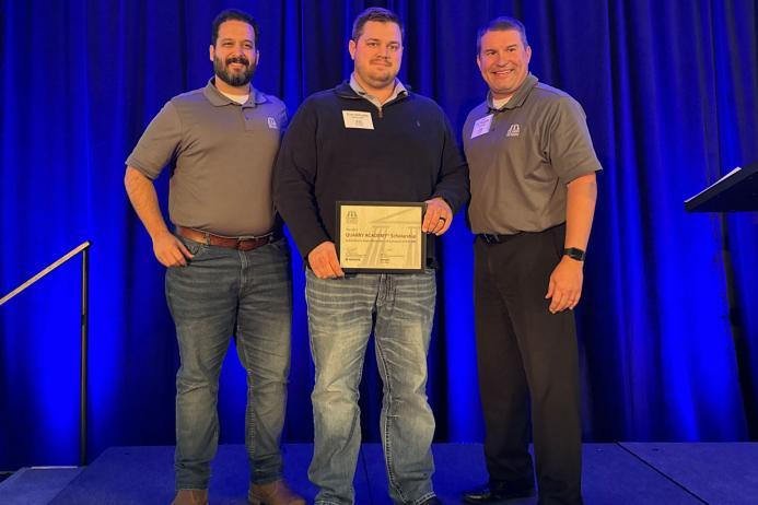 Evan McCorkle (centre) receiving his scholarship from Raphael Carmona (left) and Greg Tranor (right)