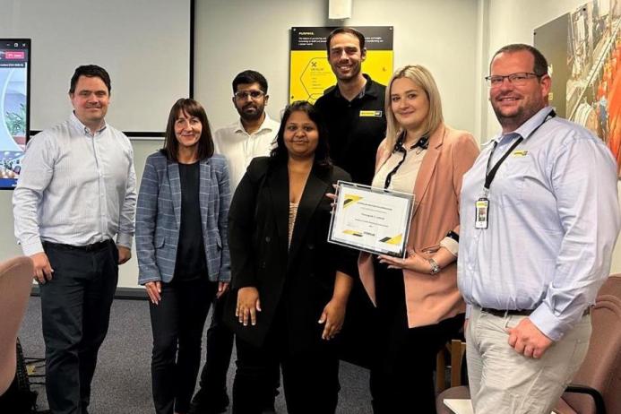 Finning UK & Ireland condition-monitoring team with their Cat certificate for ‘excellence in condition monitoring and remote services’