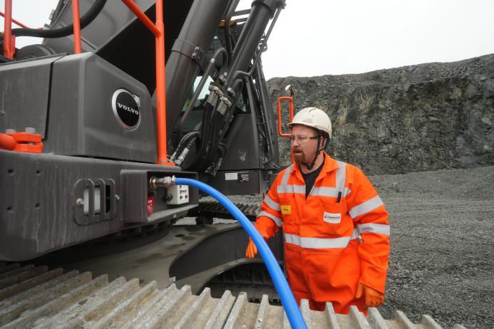 Rhys Morgan, Chepstow Plant engineer at Tarmac’s Dolyhir and Gore quarries, demonstrating the ground-level AdBlue refuelling system on the new Volvo EC500F excavator   