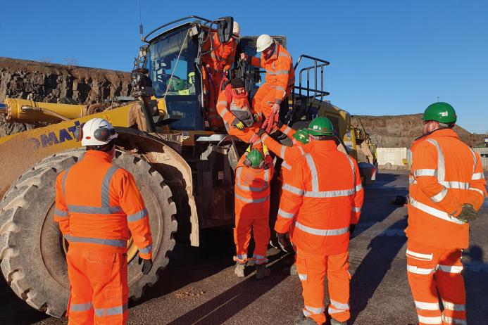 Cauldon Low – lowering a casualty from an elevated cab with two people at cab height, supported by two more people on the ground to receive the casualty