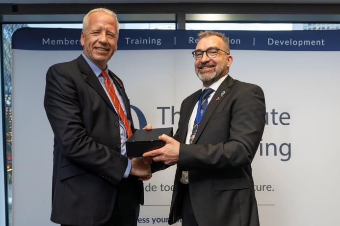 Paul Clark (left) receiving his Diploma in Surface Mining Explosives Engineering Award from IQ President Ben Williams FIQ