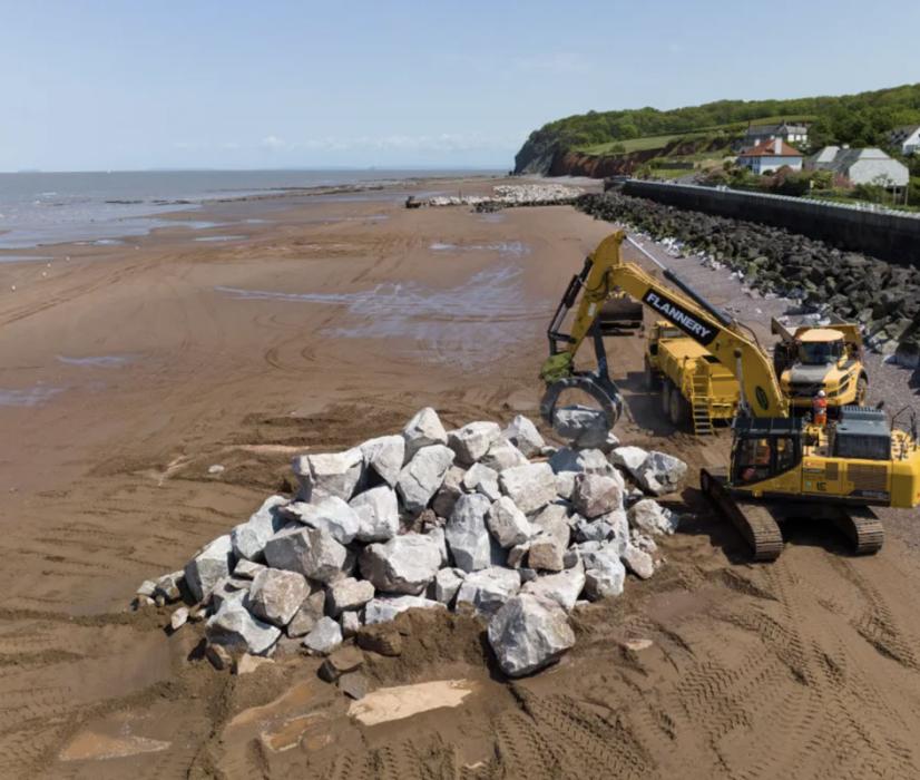 The granite armour-stone being manipulated on Blue Anchor Beach