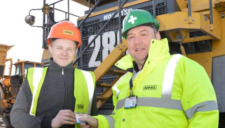 Adam Pye (left) receiving his licence card from Banks Mining’s plant operator assessor/trainer Ewan Cowie Adam Pye and Ewan Cowie