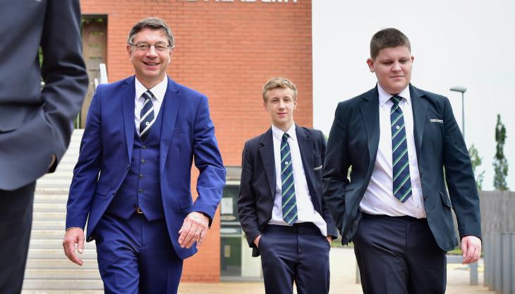 Striding off into retirement…JCB Academy principal Jim Wade, pictured with students Roan Price and Harry Eaton Jim Wade