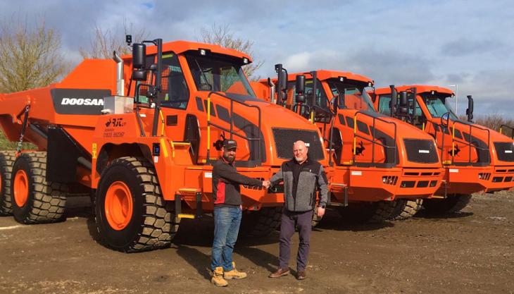 L-R: Euan Heard at the handover of the three DA30 ADTs from Darren Nicholson, area sales manager for Gordons Doosan DA30 articulated dumptrucks