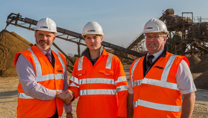 L-R: Mike Hill, chief executive of The Hills Group, congratulates Aidan Jeffreys on the successful completion of his apprenticeship, joined by Peter Andrew, group director of Hills Quarry Products Aiden Jeffreys (centre)