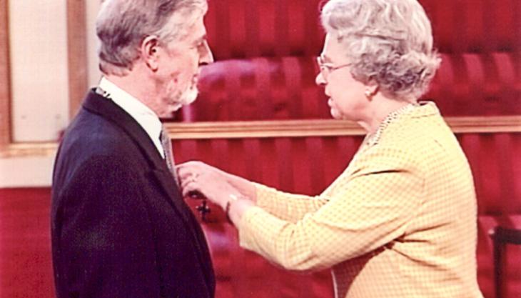 Mike Arthur receiving his MBE from the Queen