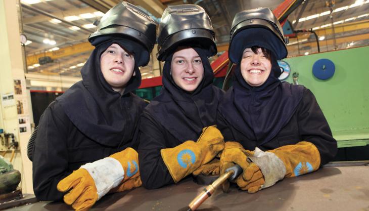 The Rowe triplets in their welding gear JCB apprentices