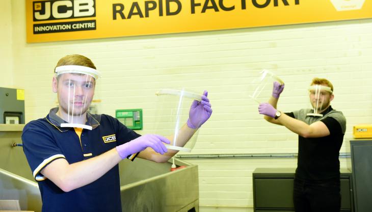 JCB employees Joe Mumby (left) and Joe Bagley with visors made at JCB JCB