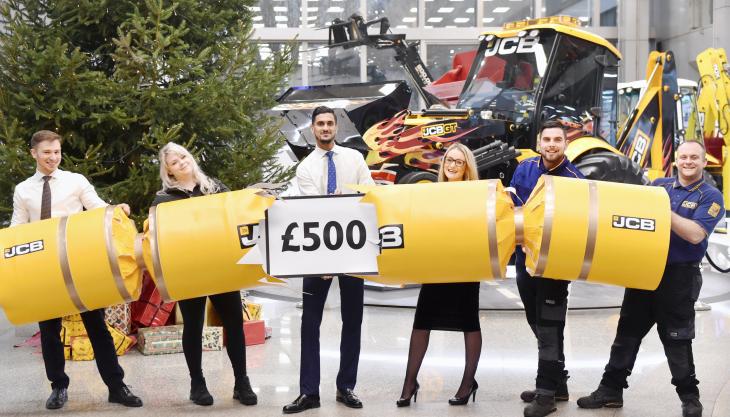 JCB staff celebrating news of their £500 Christmas bonus JCB bonus