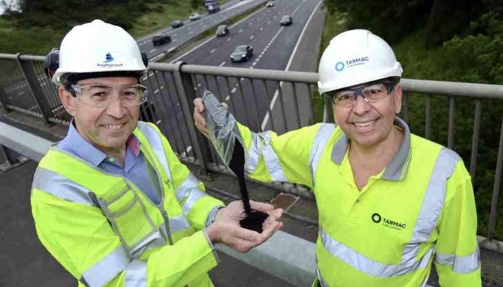 L-R: Martin Bolt of Highways England and Paul Fleetham of Tarmac above the M1 in the East Midlands with some of the rubber granules being trialled in the road surface Martin Bolt and Paul Fleetham