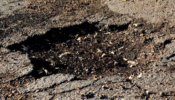 The Government has announced a further £100 million to help repair damaged roads Pothole