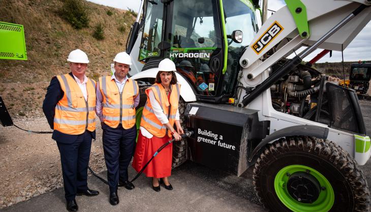 Shadow Chancellor Rachel Reeves MP tries her hand at the quick and simple task of refuelling a JCB backhoe loader with hydrogen, watched by JCB chief innovation and growth director Tim Burnhope (left) and Gary Smith, General Secretary of the GMB Union Rachel Reeves