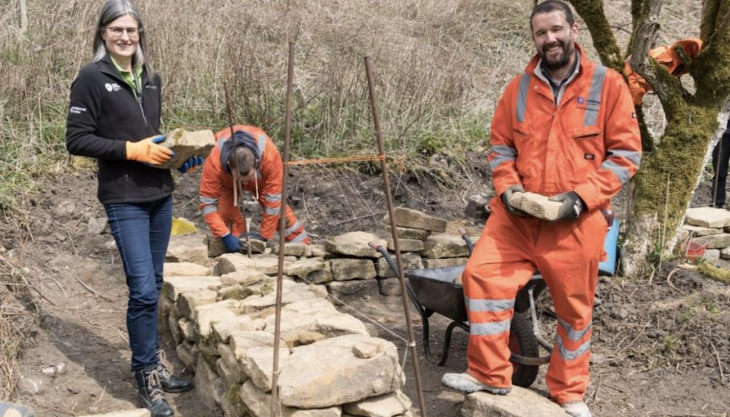 Celebrating the renewal of the volunteering partnership, Peak District National Park chief executive Sarah Fowler joins Tarmac Tunstead’s stone and powders director Pete Butterworth during a drystone walling day at Brunts Barn Sarah Fowler and Pete Butterworth
