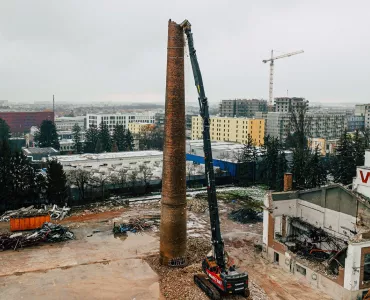 Volvo EC750E high-reach demolition excavator bringing down a 38m high chimney