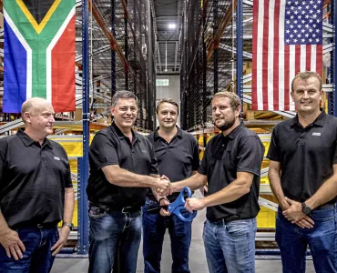 Bell Equipment group chief executive Leon Goosen (second from left) is handed the ceremonial scissors by ALC general manager Andrew Pretorius, while Bell directors, Stephen Jones, Aldo Mayer and Meltus Badenhorst look on