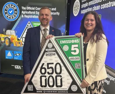 L-R: Steven Mulholland, chief executive officer of the CPA (Construction Plant Hire Association), and Beth Abbott, marketing and communications manager with the CEA, celebrating CESAR’s 650,000th registration milestone