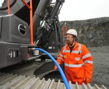 Rhys Morgan, Chepstow Plant engineer at Tarmac’s Dolyhir and Gore quarries, demonstrating the ground-level AdBlue refuelling system on the new Volvo EC500F excavator   