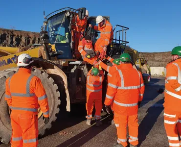 Cauldon Low – lowering a casualty from an elevated cab with two people at cab height, supported by two more people on the ground to receive the casualty