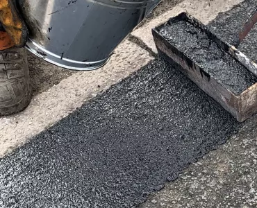 Elastomac rubberized road repair material