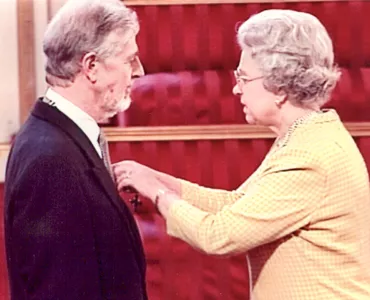Mike Arthur receiving his MBE from the Queen