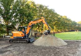 Develon DX85R-7 compact excavator in operation 