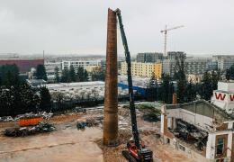 Volvo EC750E high-reach demolition excavator bringing down a 38m high chimney