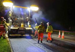 Paving machine laying asphalt containing hydrated lime on the A38 in Devon