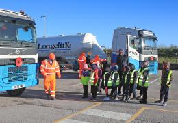 Cromford Primary School students are taken through road safety exercises with Longcliffe health and safety manager Tony Woodroffe (left)