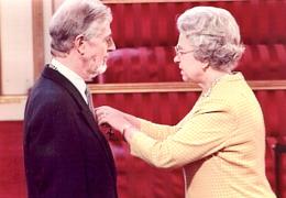 Mike Arthur receiving his MBE from the Queen