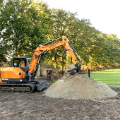 Develon DX85R-7 compact excavator in operation 