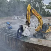 Schnittger cutting through the huge, ring-shaped rim of the basin with an excavator-mounted Kemroc DMW 220 cutter wheel