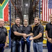 Bell Equipment group chief executive Leon Goosen (second from left) is handed the ceremonial scissors by ALC general manager Andrew Pretorius, while Bell directors, Stephen Jones, Aldo Mayer and Meltus Badenhorst look on