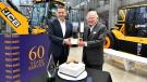 Anthony Bamford (right) receives his 60 year long service award from JCB CEO Graeme Macdonald.
